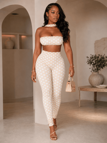 Model wearing retro polka dot crop top set featuring a bandeau top and high-waist leggings.