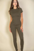 Model showcasing the Essential Fit Short Sleeve Two-Piece Legging Set in olive green, highlighting its fitted design.