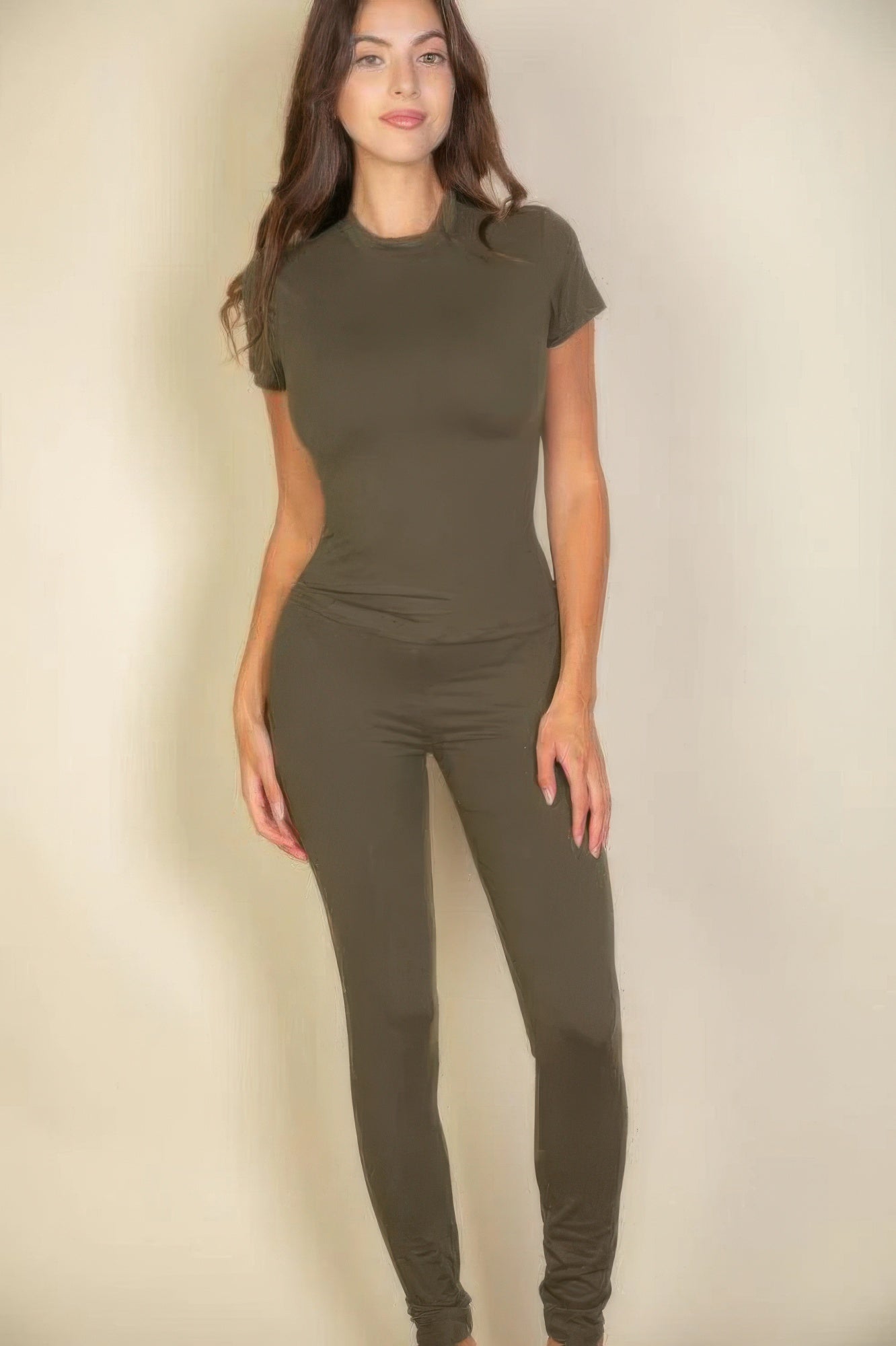 Model showcasing the Essential Fit Short Sleeve Two-Piece Legging Set in olive green, highlighting its fitted design.