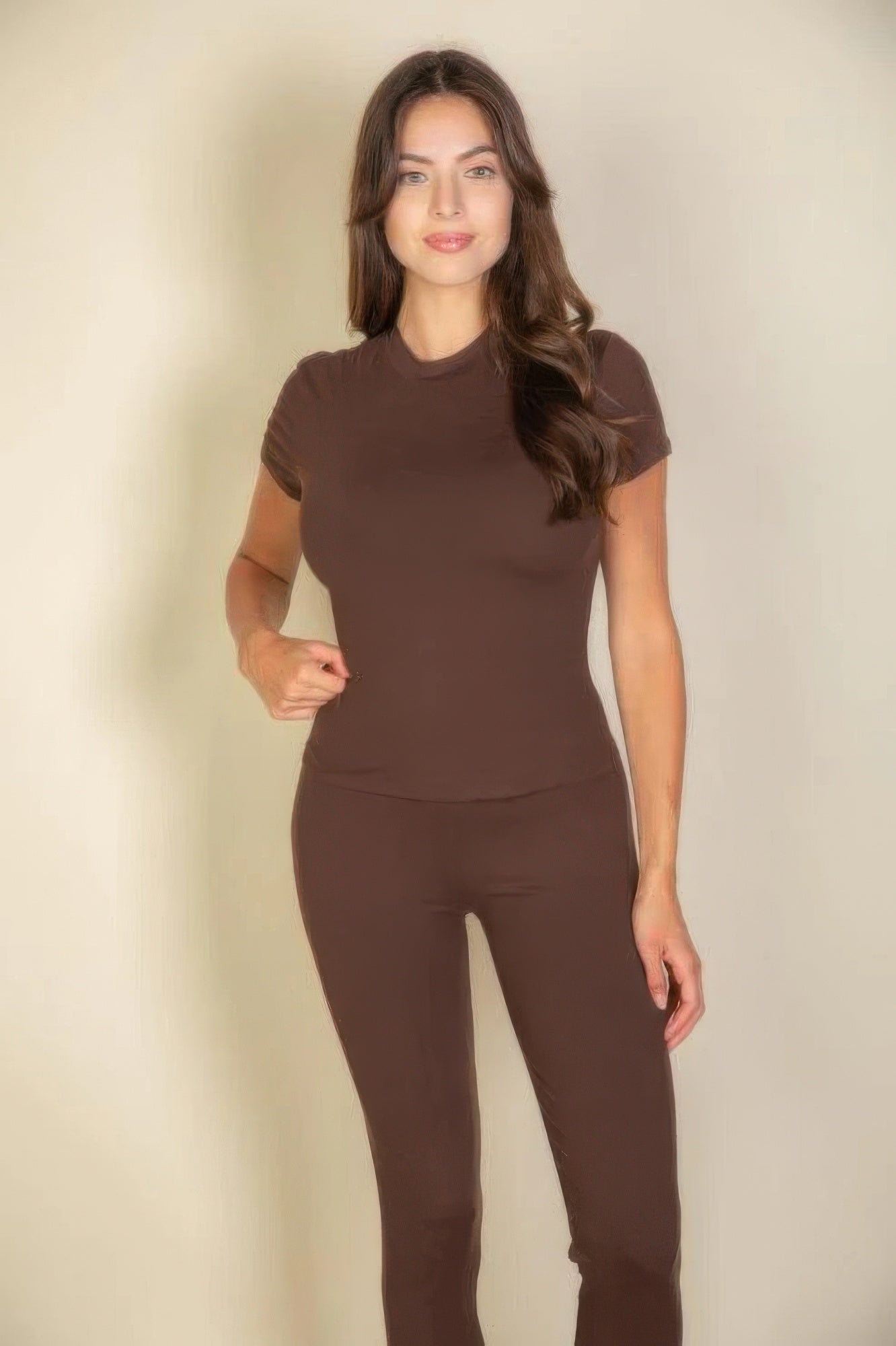 Model wearing an Essential Fit Short Sleeve Two-Piece Legging Set in brown, showcasing a fitted short sleeve top and leggings.