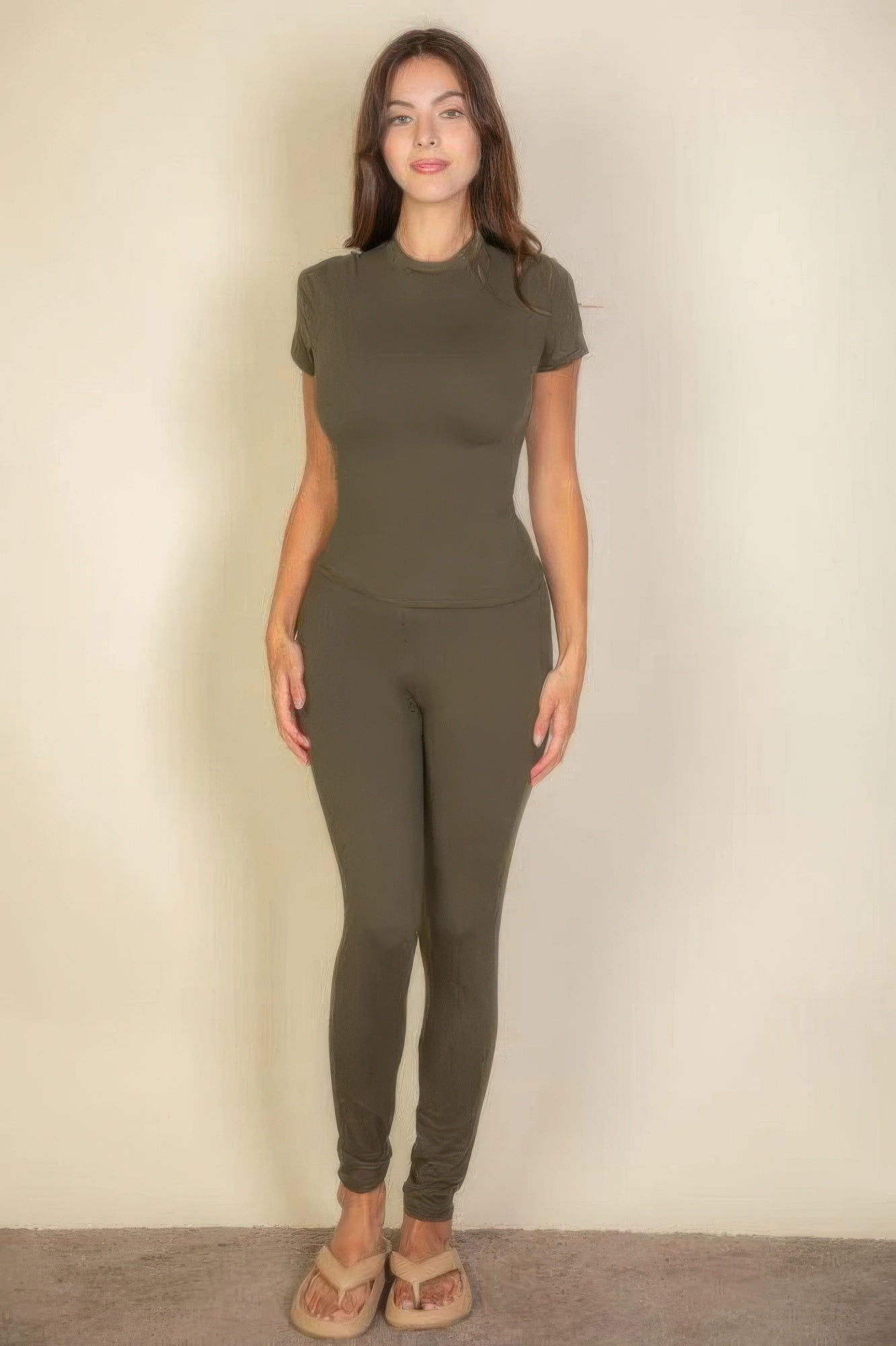 Model showcasing the Essential Fit Short Sleeve Two-Piece Legging Set in olive green, highlighting its fit and simplicity.