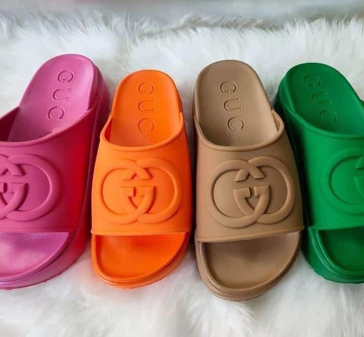 Women’s Platform Slide Sandals in vibrant colors including pink, orange, tan, and green on a fluffy white surface.