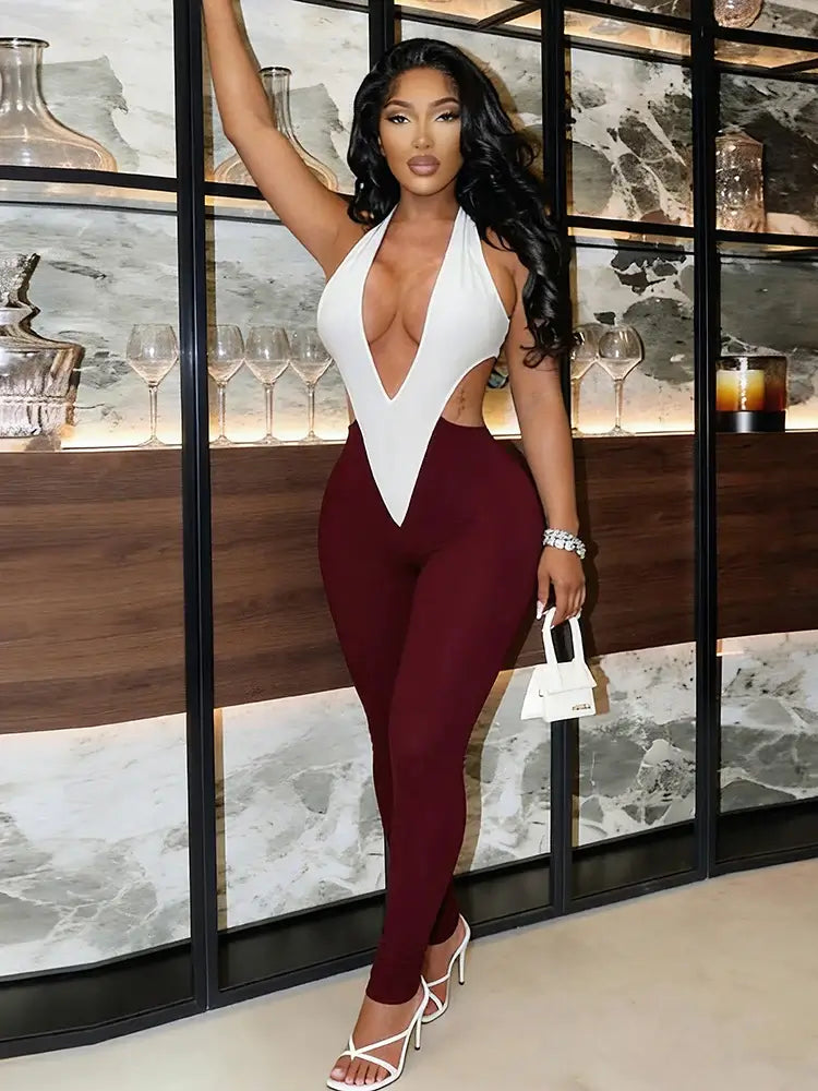 Sculpted colorblock plunge halter jumpsuit in white and burgundy.