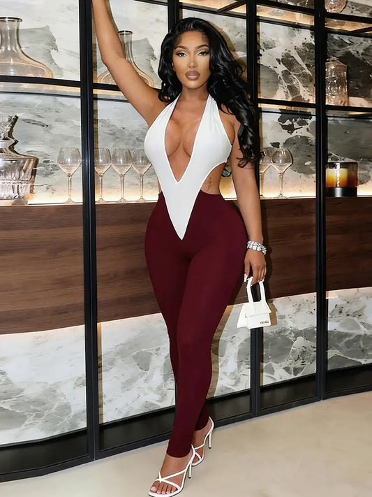 Sculpted colorblock plunge halter jumpsuit in white and burgundy.