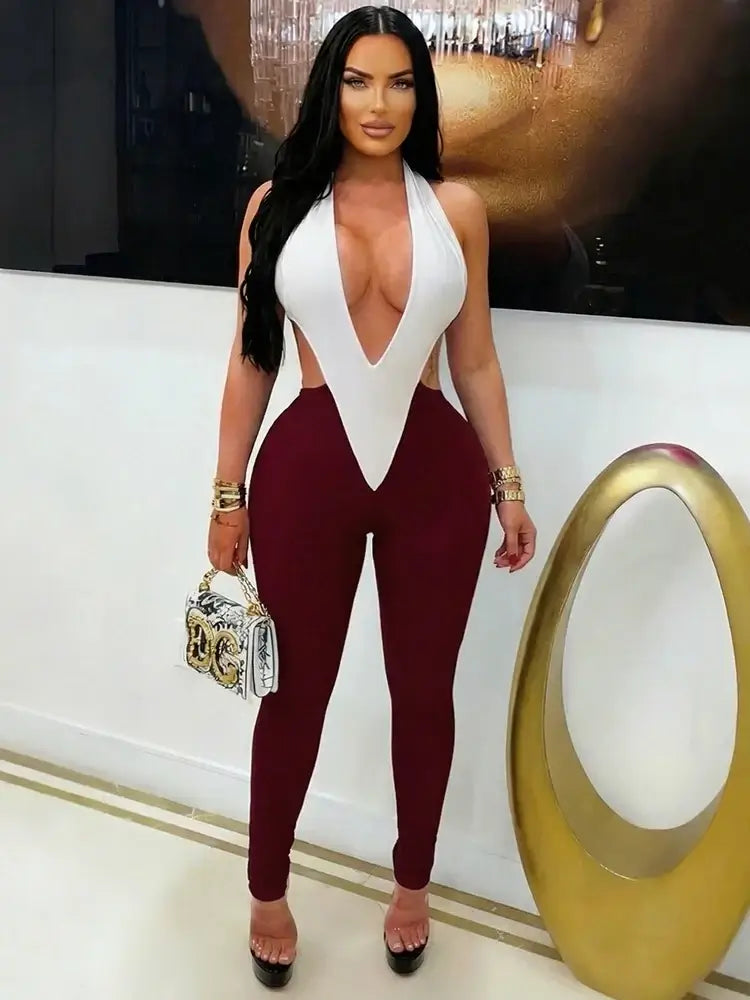 Sculpted colorblock plunge halter jumpsuit with white bodice and burgundy fitted pants, showcasing a daring neckline.