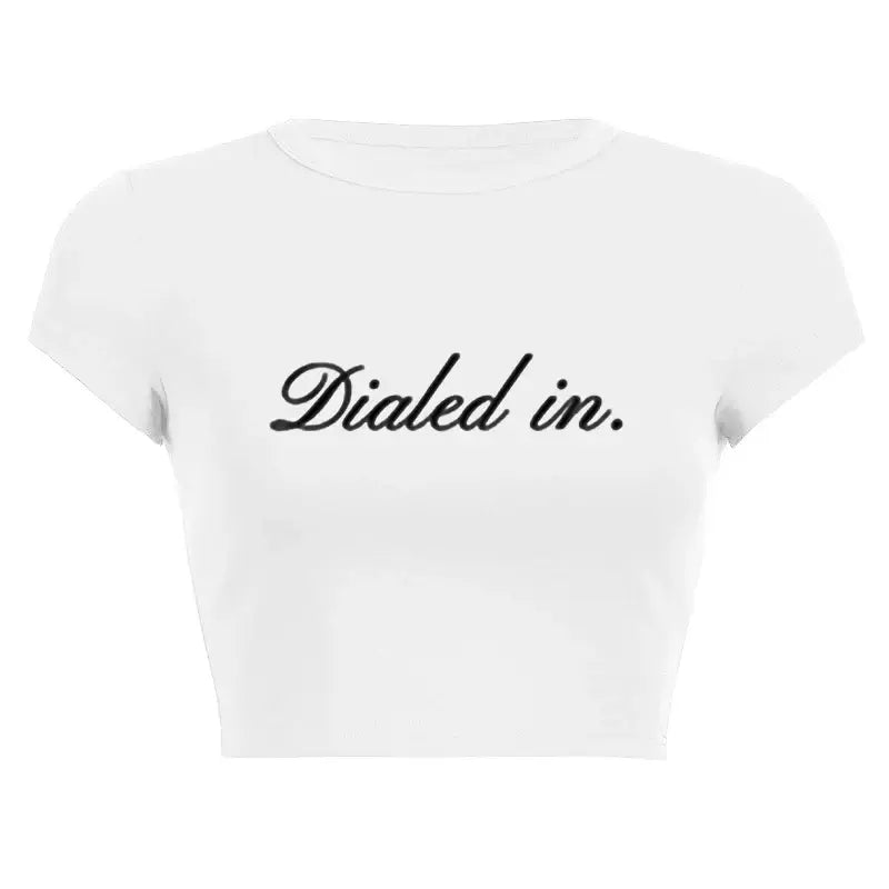 Women’s Assorted Graphic Short Sleeve Crop Tee with 'Dialed in.' slogan on a white background.