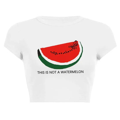Women’s Assorted Graphic Short Sleeve Crop Tee with watermelon graphic and slogan 'THIS IS NOT A WATERMELON' on white background.