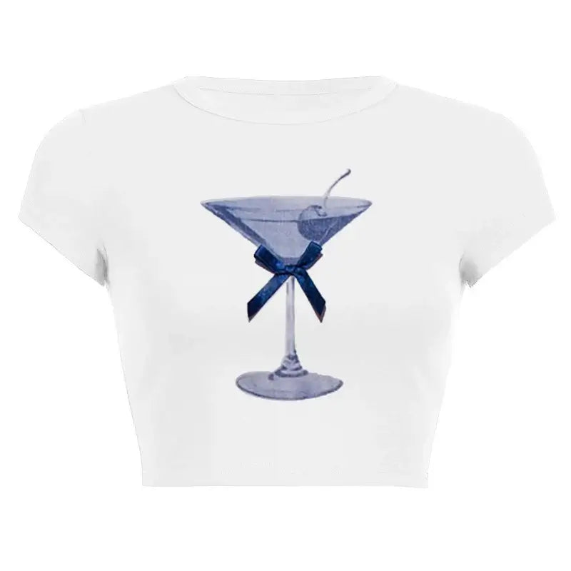 Women’s Assorted Graphic Short Sleeve Crop Tee with a blue cocktail glass illustration and bow on a white background.