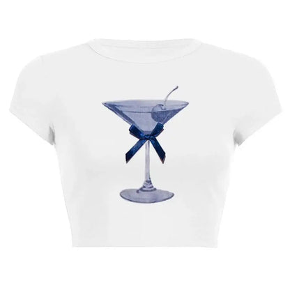 Women’s Assorted Graphic Short Sleeve Crop Tee with a blue cocktail glass illustration and bow on a white background.
