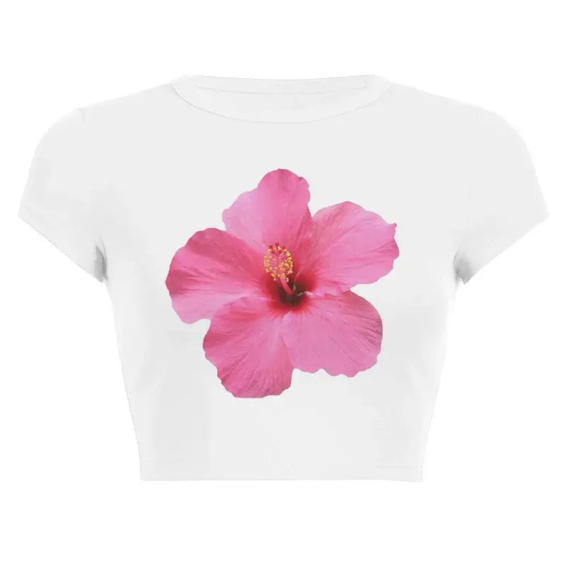 Women’s Assorted Graphic Short Sleeve Crop Tee featuring a vibrant pink hibiscus flower design on a white background.