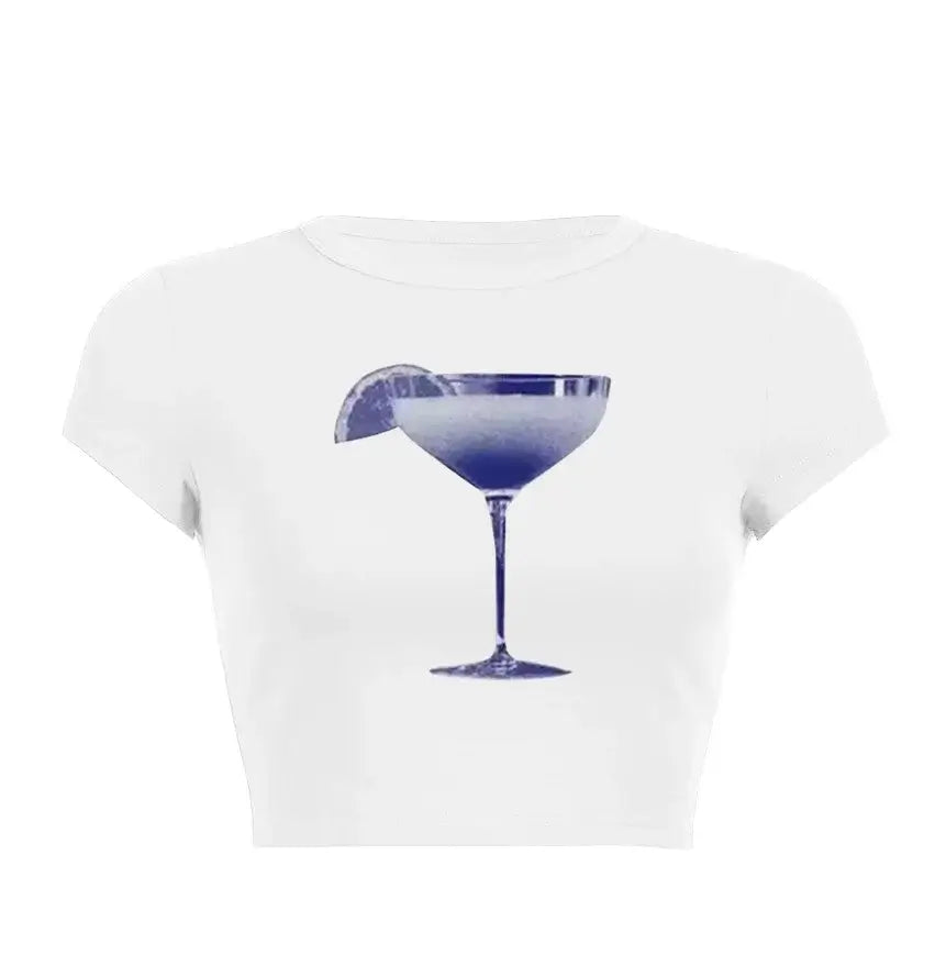 Women’s Assorted Graphic Short Sleeve Crop Tee featuring a stylish blue cocktail graphic on a white background.