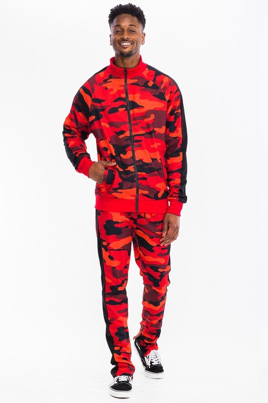 Camo tracksuit set featuring a red and black camouflage design, modeled by a man in a slim fit 2-piece streetwear outfit.