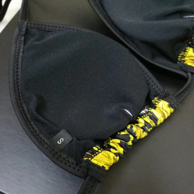 Luxury print swimsuit bikini top in black and yellow with soft padding and adjustable straps.