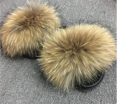 Plush faux fur slides featuring luxurious brown fur and a black slip-on sole for ultimate comfort and style.