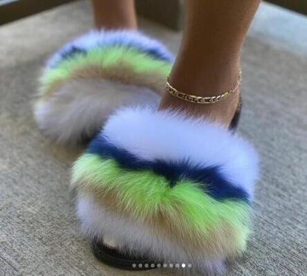 Plush faux fur slides featuring vibrant green, blue, and white colors, perfect for stylish comfort.