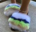 Plush faux fur slides featuring vibrant green, blue, and white colors, perfect for stylish comfort.