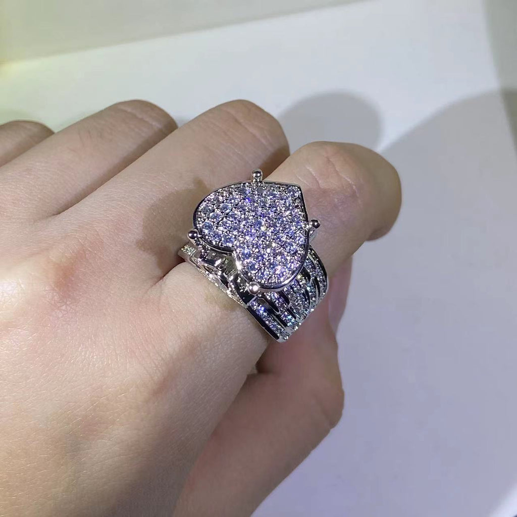 Heart-shaped zircon ring featuring a prong setting with sparkling zircon stones on a silver band.