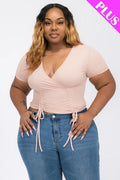 Model showcasing a wrap tie v-neck fitted shirt paired with high-waisted jeans, emphasizing curves and comfort.