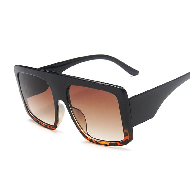 Fashion sunglasses with UV protection featuring a bold black frame and gradient lenses.